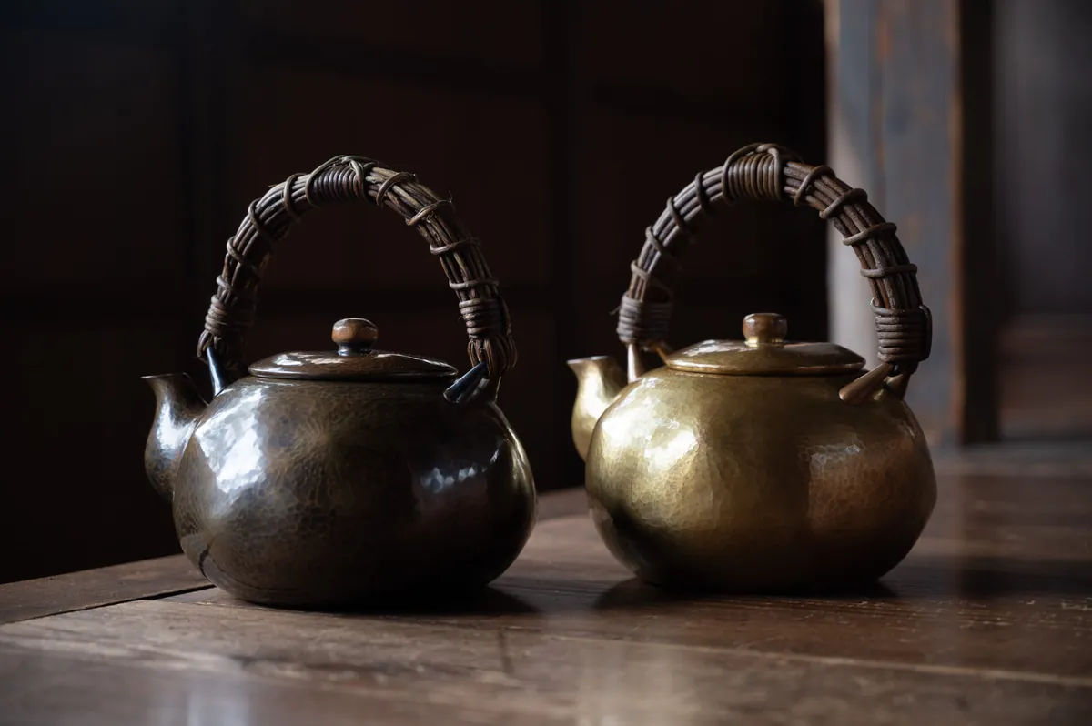 Master craftsman demonstrating the traditional tsuiki hammering technique on copper