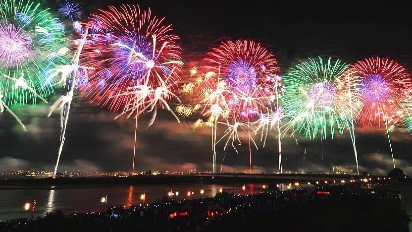 Traditional hanabi fireworks illuminating summer night sky in Japan